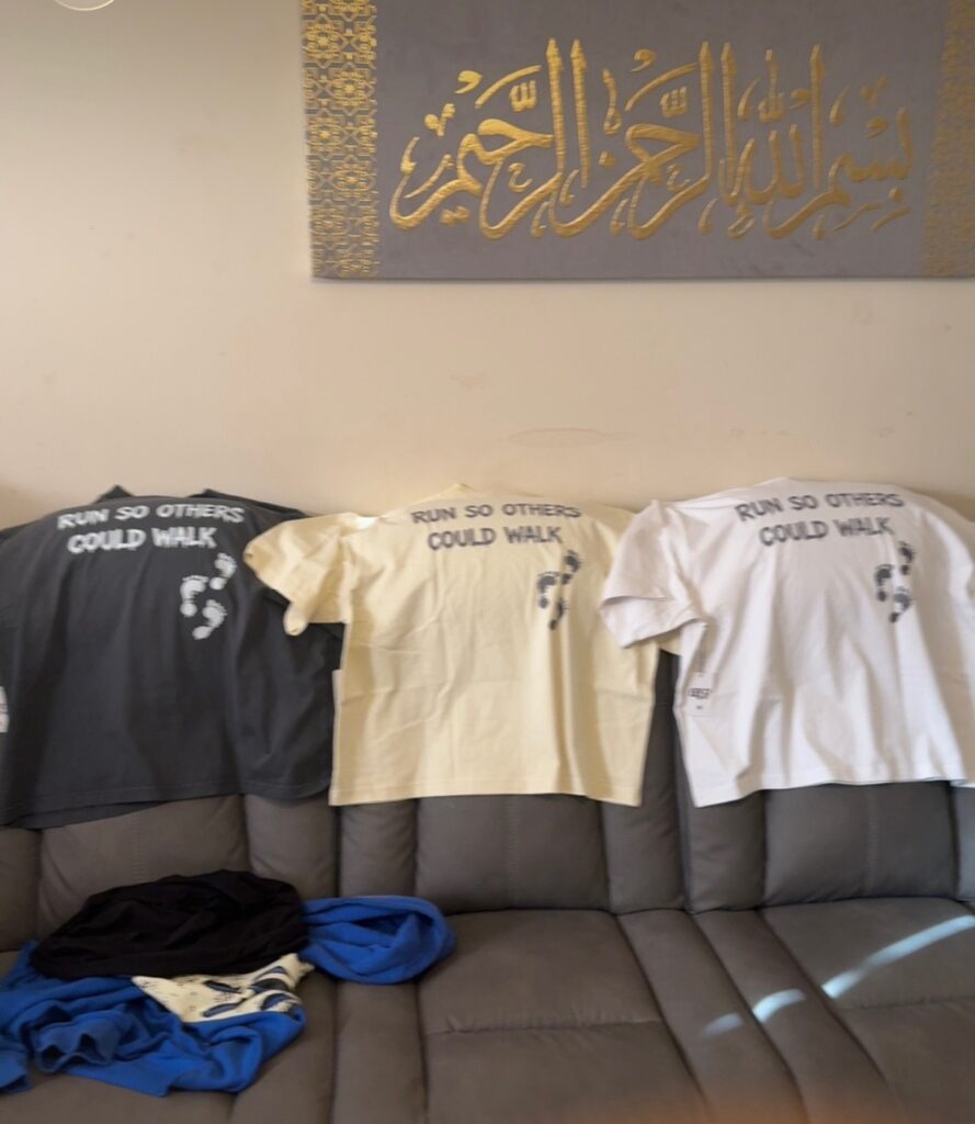 Bluprynttt 'Run So Others Could Walk' tees in black, cream, and white.