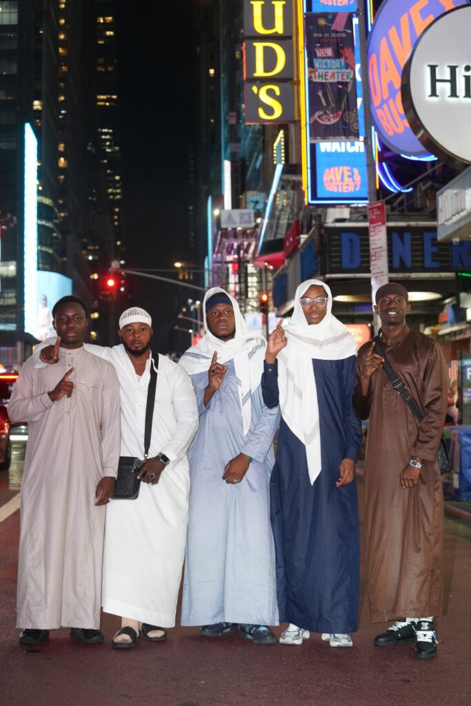 The Steppas in thobes in Times Square at night